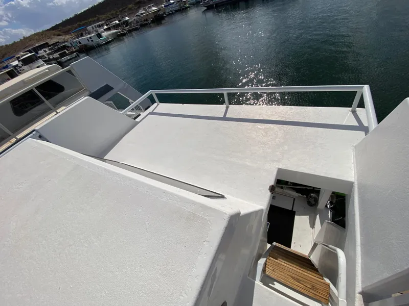 Slide: The Image of 1988 Three Buoys 4412 boat deck overlooking marina with calm water and clear sky. - 36