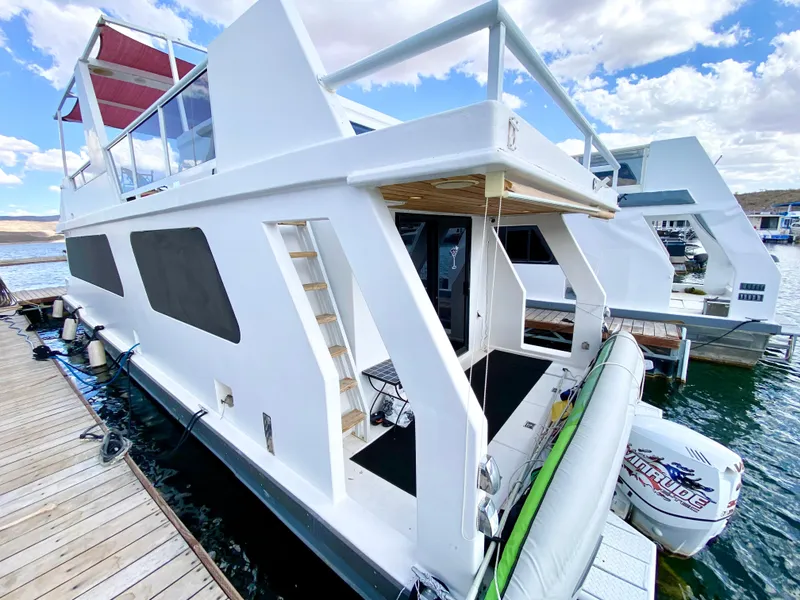 Slide: The Image of Luxurious 1988 Three Buoys 4412 houseboat interior with modern kitchen and cozy seating area. - 5