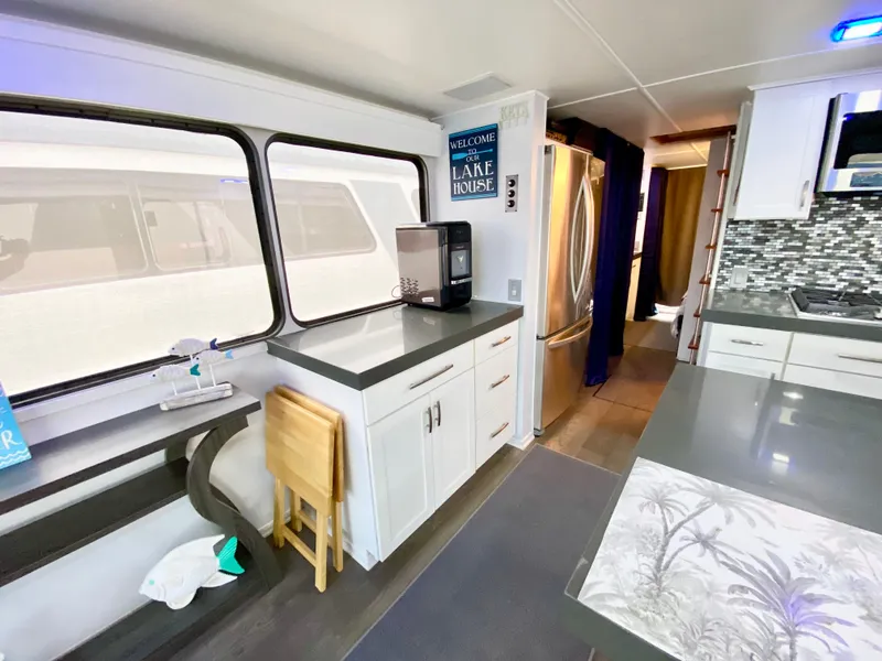Slide: The Image of Interior of 1988 Three Buoys 4412 houseboat with modern kitchen and dining area. - 8