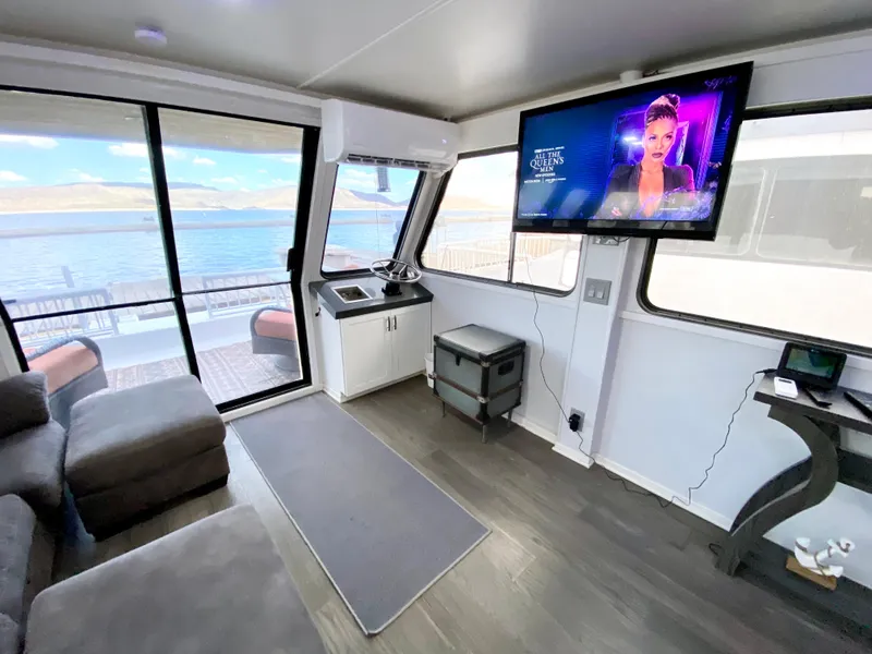 Slide: The Image of Interior of 1988 Three Buoys 4412 houseboat with modern decor and lake view. - 14