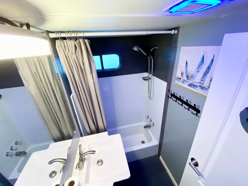 Slide: The Image of Modern bathroom in 1988 Three Buoys 4412 boat with shower, sink, and nautical decor. - 16