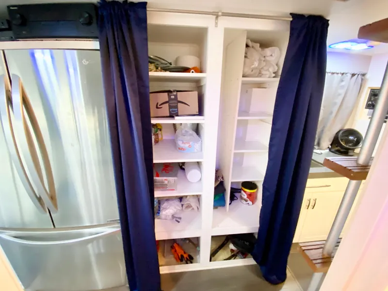 Slide: The Image of 1988 Three Buoys 4412 interior with open shelving and stainless steel refrigerator. - 19