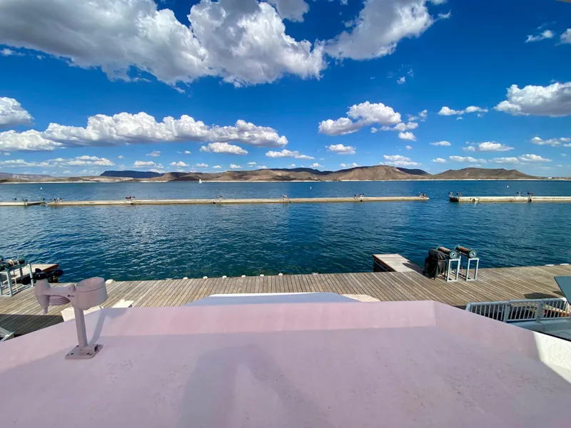 Slide: The Image of View from 1988 Three Buoys 4412 boat, overlooking serene lake and mountains under blue sky. - 34