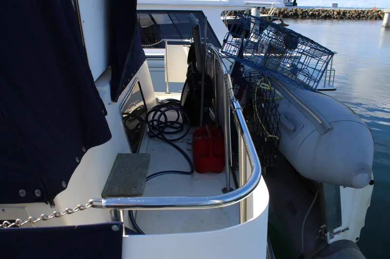 Slide: The Image of 1987 Chris-Craft 381 Catalina boat deck with equipment and inflatable dinghy. - 11