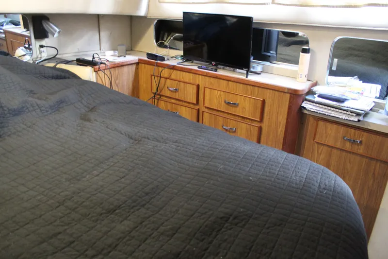 Slide: The Image of Interior of 1987 Chris-Craft 381 Catalina with bed, TV, and wooden cabinetry. - 14