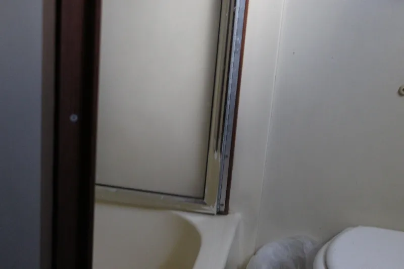 Slide: The Image of Bathroom interior of 1987 Chris-Craft 381 Catalina yacht, featuring shower and toilet. - 16