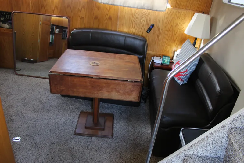 Slide: The Image of Interior of 1987 Chris-Craft 381 Catalina with wooden table and leather seating. - 28