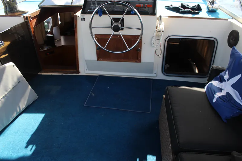 Slide: The Image of 1987 Chris-Craft 381 Catalina interior with steering wheel and blue carpet. - 5