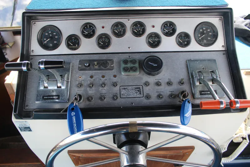 Slide: The Image of Control panel of a 1987 Chris-Craft 381 Catalina boat with gauges and levers. - 6