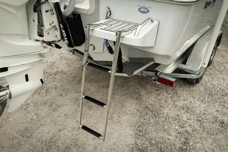 Slide: The Image of 2026 Tidewater 2500 Carolina Bay boat with ladder and trailer on gravel surface. - 11