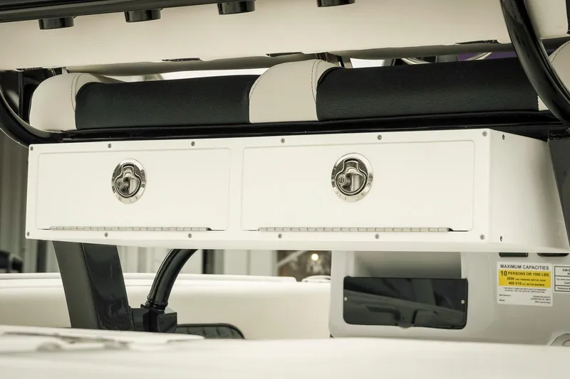 Slide: The Image of 2026 Tidewater 2500 Carolina Bay boat console with storage compartments and seating. - 12