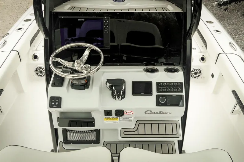 Slide: The Image of 2026 Tidewater 2500 Carolina Bay boat console with steering wheel and electronic controls. - 19
