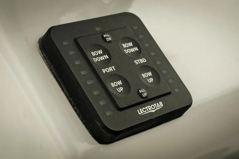 Slide: The Image of Control panel on 2026 Tidewater 2500 Carolina Bay boat, featuring Lectrotab trim tab buttons. - 20