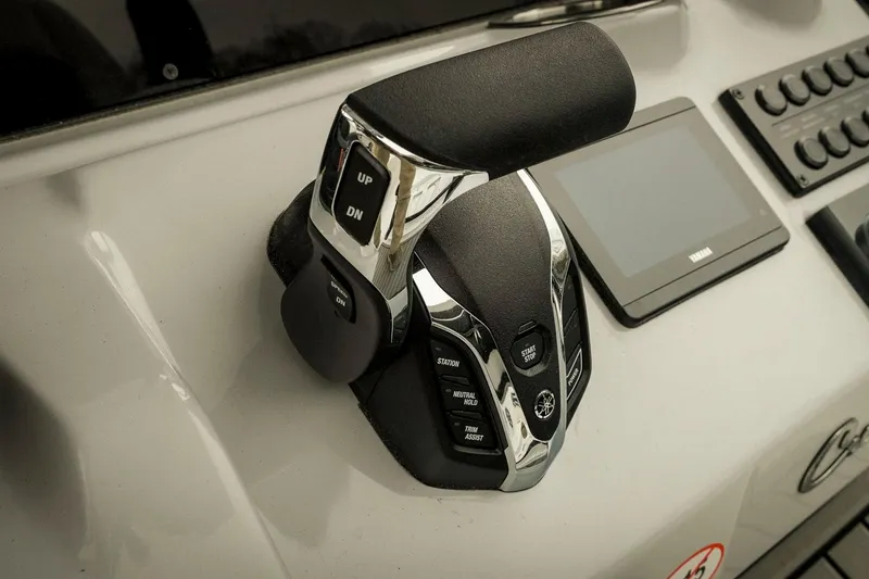 Slide: The Image of Control panel of 2026 Tidewater 2500 Carolina Bay boat with throttle and display. - 22