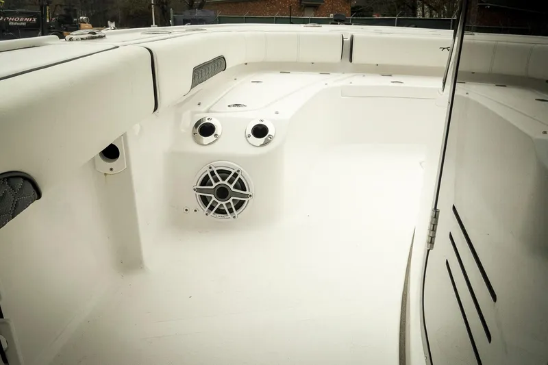 Slide: The Image of 2026 Tidewater 2500 Carolina Bay boat interior with speaker and seating area. - 25