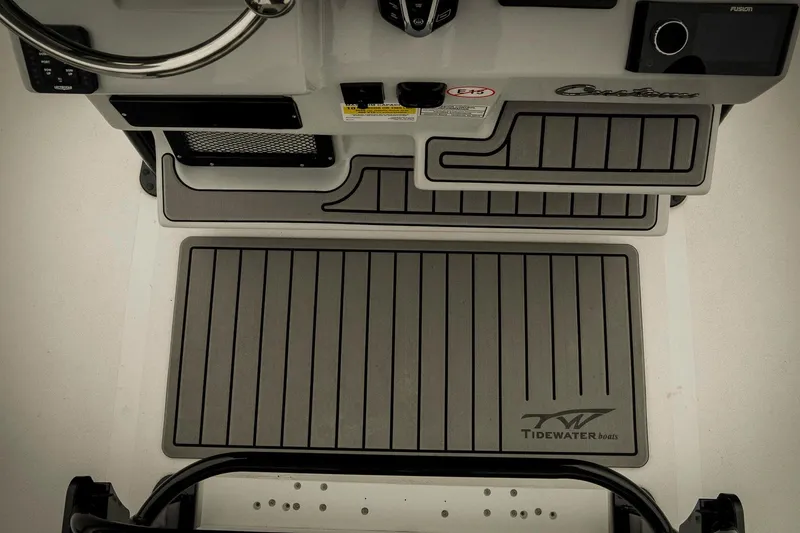 Slide: The Image of 2026 Tidewater 2500 Carolina Bay boat interior with steering wheel and branded floor mats. - 29