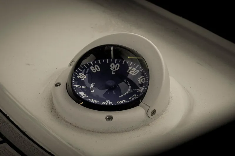 Slide: The Image of Compass on 2026 Tidewater 2500 Carolina Bay boat dashboard, showing navigation directions. - 30