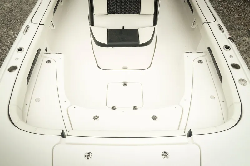 Slide: The Image of 2026 Tidewater 2500 Carolina Bay boat interior with white seating and storage compartments. - 31