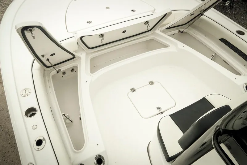Slide: The Image of 2026 Tidewater 2500 Carolina Bay boat interior with open storage compartments. - 33