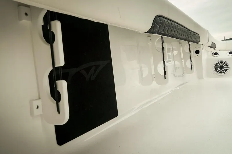 Slide: The Image of 2026 Tidewater 2500 Carolina Bay interior with rod holders and speaker detail. - 48