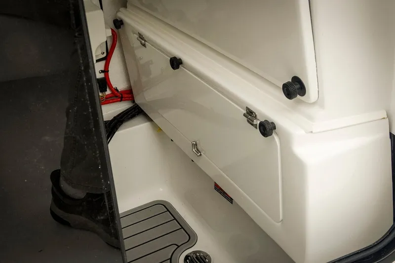 Slide: The Image of 2026 Tidewater 2500 Carolina Bay boat interior storage compartment with visible wiring. - 50