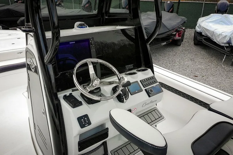 Slide: The Image of 2026 Tidewater 2500 Carolina Bay boat dashboard with steering wheel and controls. - 57