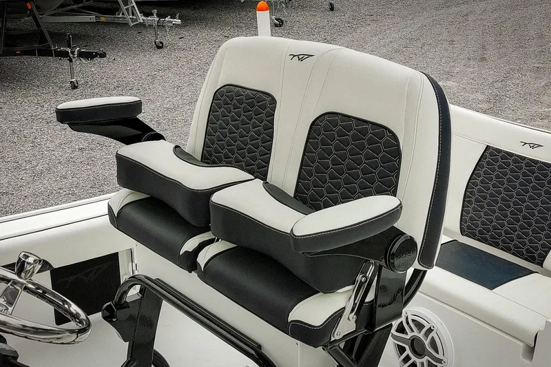 Slide: The Image of 2026 Tidewater 2500 Carolina Bay boat seats with black and white upholstery and armrests. - 58