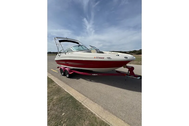 Slide: The Image of 2007 Sea Ray 200 Sundeck boat on a trailer under a clear sky. - 3