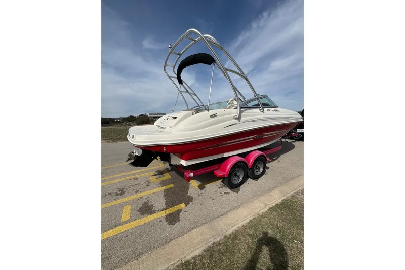 Slide: The Image of 2007 Sea Ray 200 Sundeck boat on a trailer under a clear blue sky. - 4