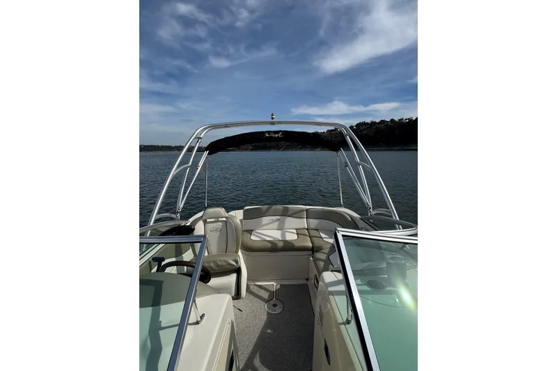 Slide: The Image of 2007 Sea Ray 200 Sundeck boat on calm water under a blue sky. - 8