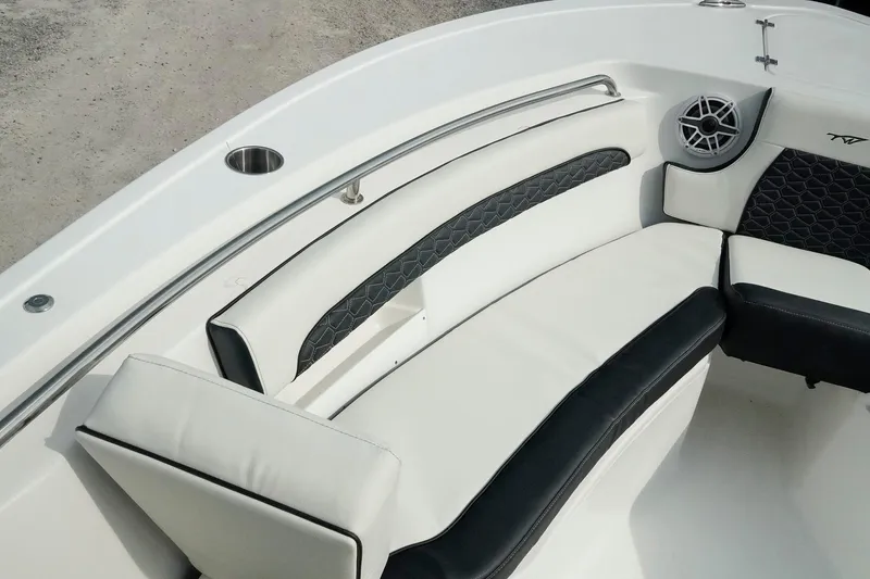 Slide: The Image of 2026 Tidewater 232 LXF boat interior with cushioned seating and speaker. - 15