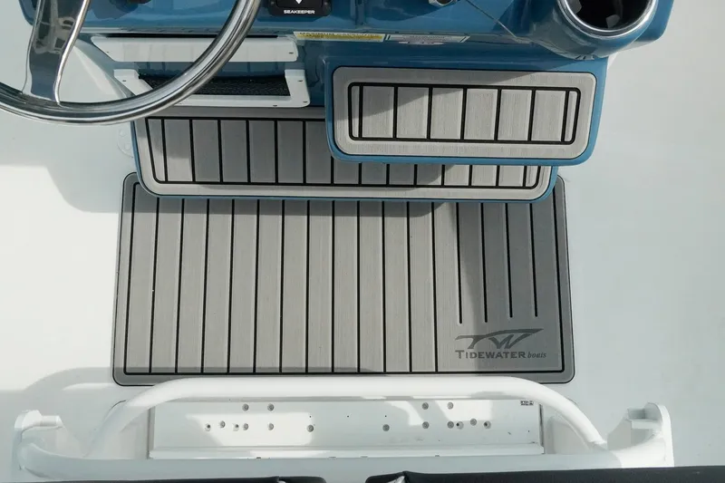 Slide: The Image of 2026 Tidewater 232 LXF boat deck with branded non-slip flooring. - 18
