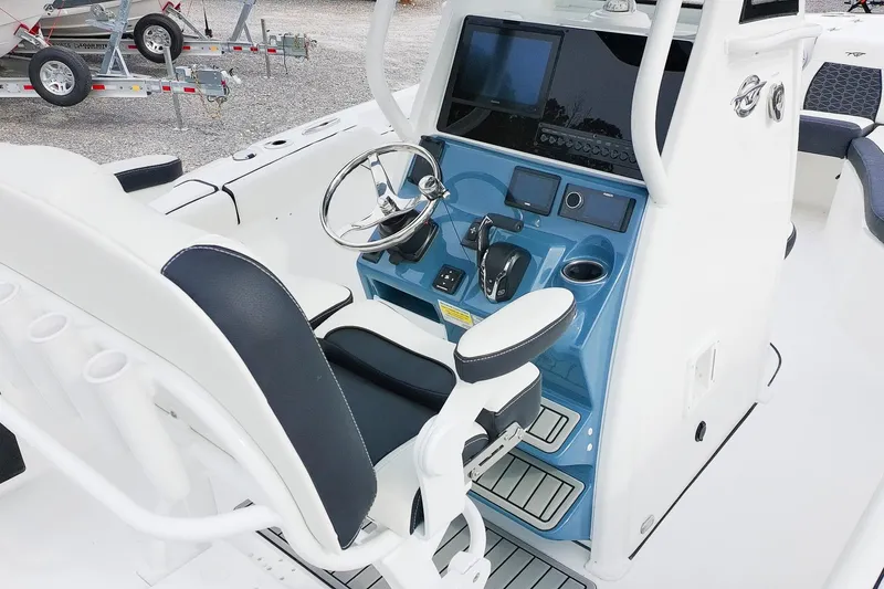 Slide: The Image of 2026 Tidewater 232 LXF boat cockpit with steering wheel and control panel. - 20
