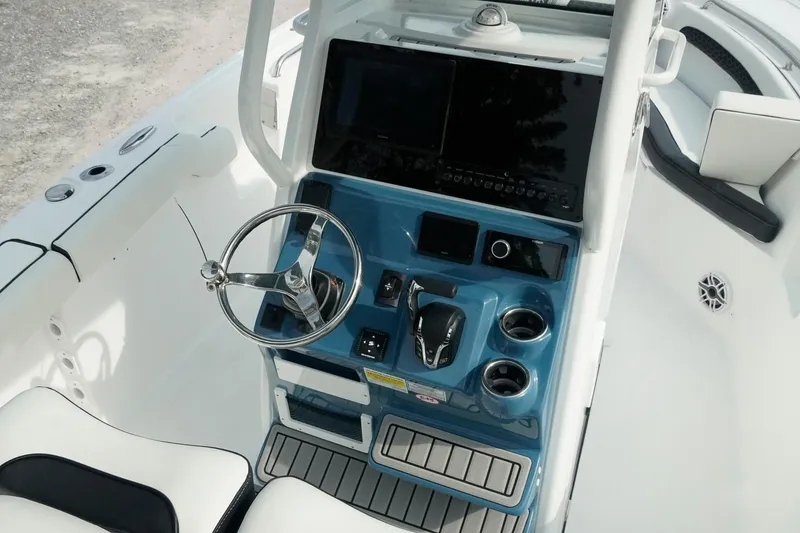 Slide: The Image of 2026 Tidewater 232 LXF boat dashboard with steering wheel and control panel. - 21
