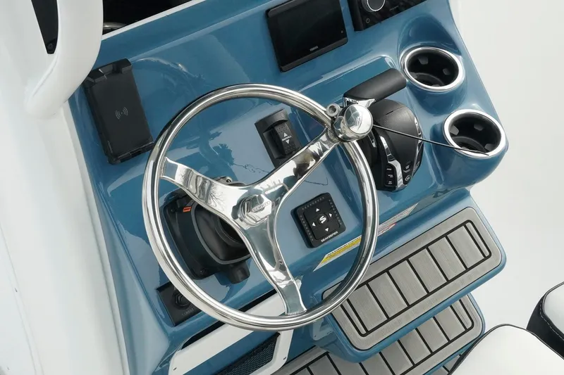 Slide: The Image of 2026 Tidewater 232 LXF boat helm with steering wheel and controls. - 22