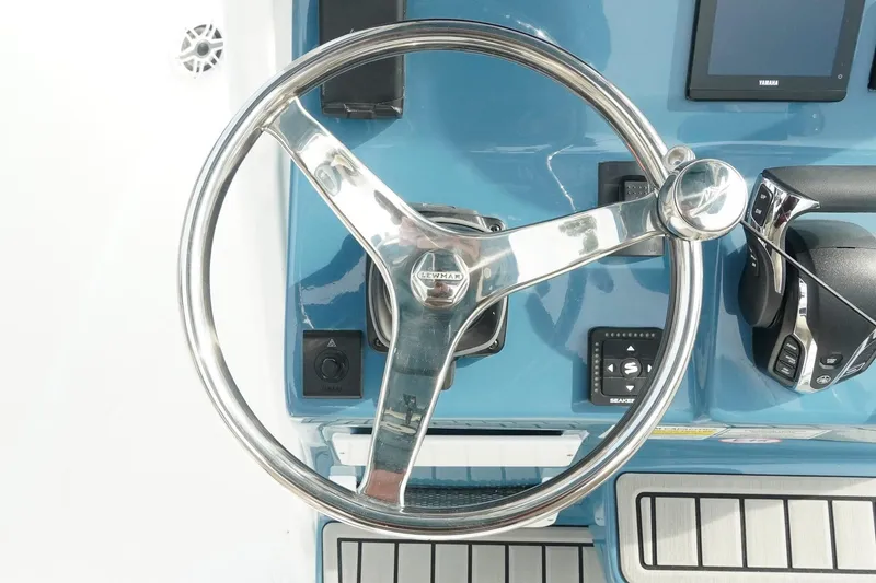 Slide: The Image of Steering wheel of 2026 Tidewater 232 LXF boat, featuring modern controls and sleek design. - 23