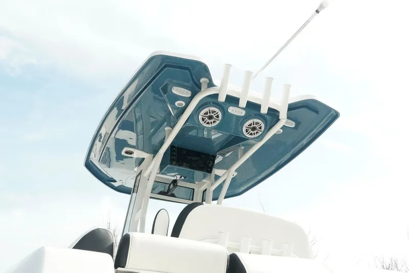 Slide: The Image of 2026 Tidewater 232 LXF boat with sleek blue T-top and integrated speakers. - 30