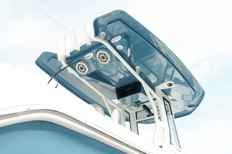 Slide: The Image of 2026 Tidewater 232 LXF boat with blue T-top and mounted speakers. - 31