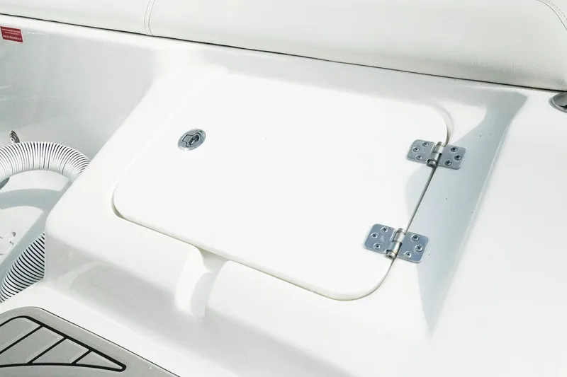 Slide: The Image of 2026 Tidewater 232 LXF boat storage compartment with white finish and metal hinges. - 37