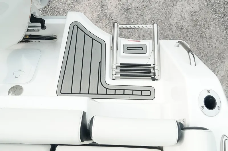 Slide: The Image of 2026 Tidewater 232 LXF boat swim platform with ladder and non-slip surface. - 38