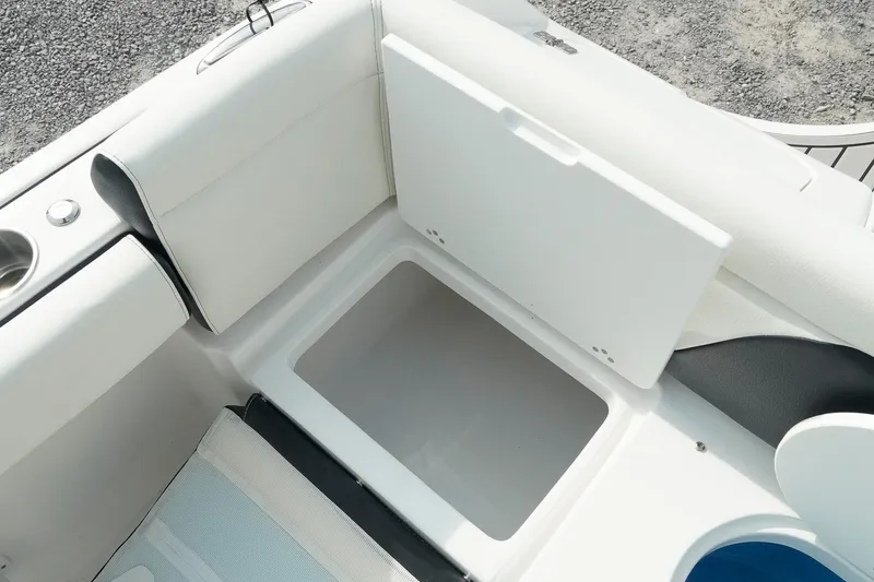 Slide: The Image of 2026 Tidewater 232 LXF boat interior storage compartment with open lid. - 44