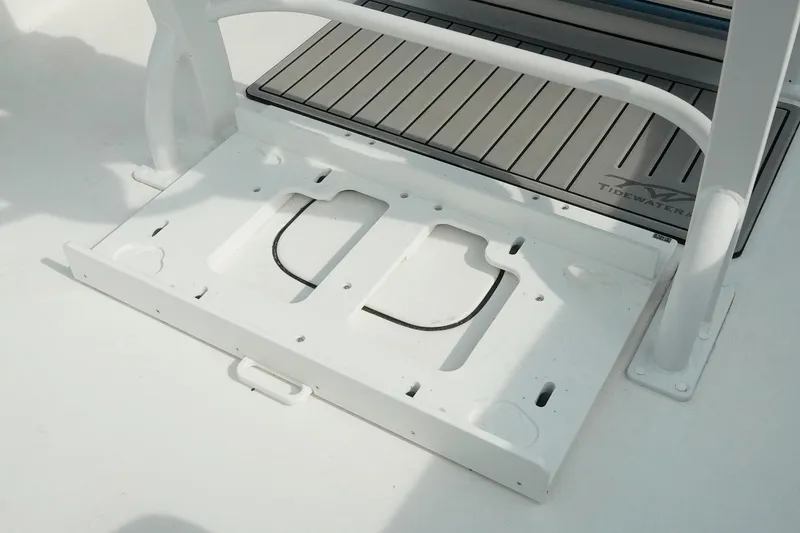 Slide: The Image of 2026 Tidewater 232 LXF boat deck with storage compartment and branded mat. - 48