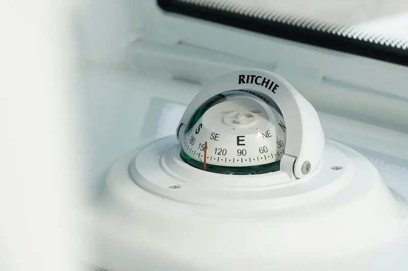 Slide: The Image of Compass on 2026 Tidewater 232 LXF boat dashboard, featuring Ritchie brand. - 50