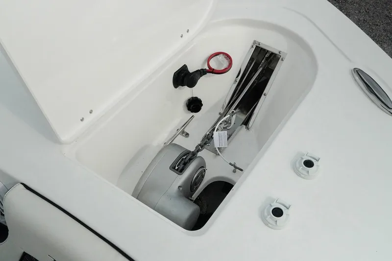 Slide: The Image of 2026 Tidewater 232 LXF boat anchor compartment with winch and storage features. - 51