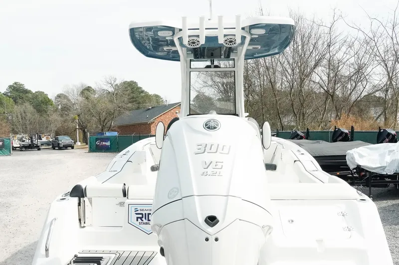 Slide: The Image of 2026 Tidewater 232 LXF boat with Yamaha 300 V6 engine, parked outdoors. - 6