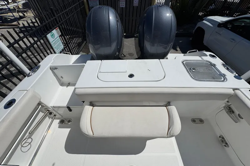 Slide: The Image of 2022 Sea Hunt Gamefish 25 boat interior with dual engines and seating area. - 1