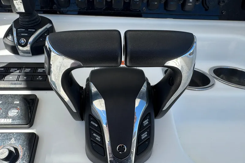 Slide: The Image of Throttle controls on a 2022 Sea Hunt Gamefish 25 boat dashboard. - 12