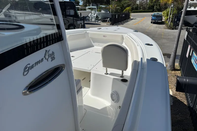 Slide: The Image of 2022 Sea Hunt Gamefish 25 boat, white interior, docked outdoors. - 15