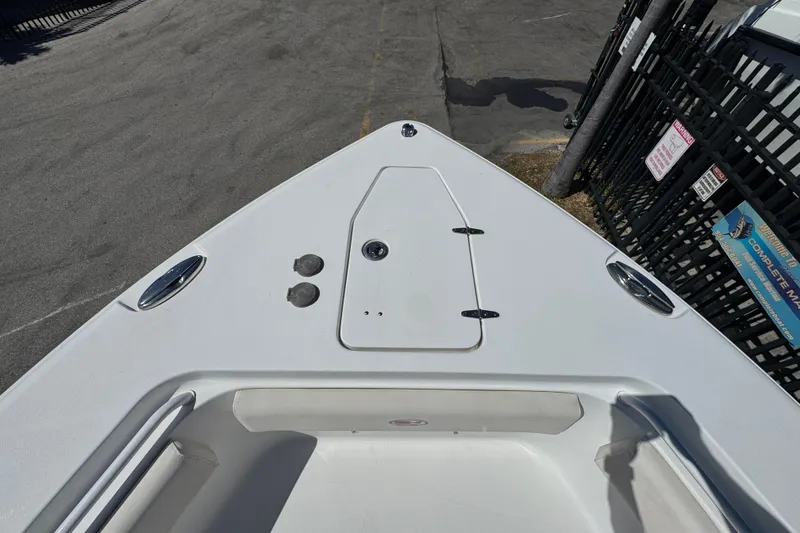 Slide: The Image of 2022 Sea Hunt Gamefish 25 boat bow view, featuring sleek design and storage hatch. - 18