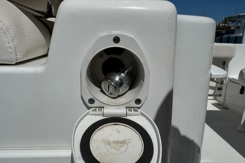 Slide: The Image of 2022 Sea Hunt Gamefish 25 boat detail showing a metal fitting and white seating. - 23